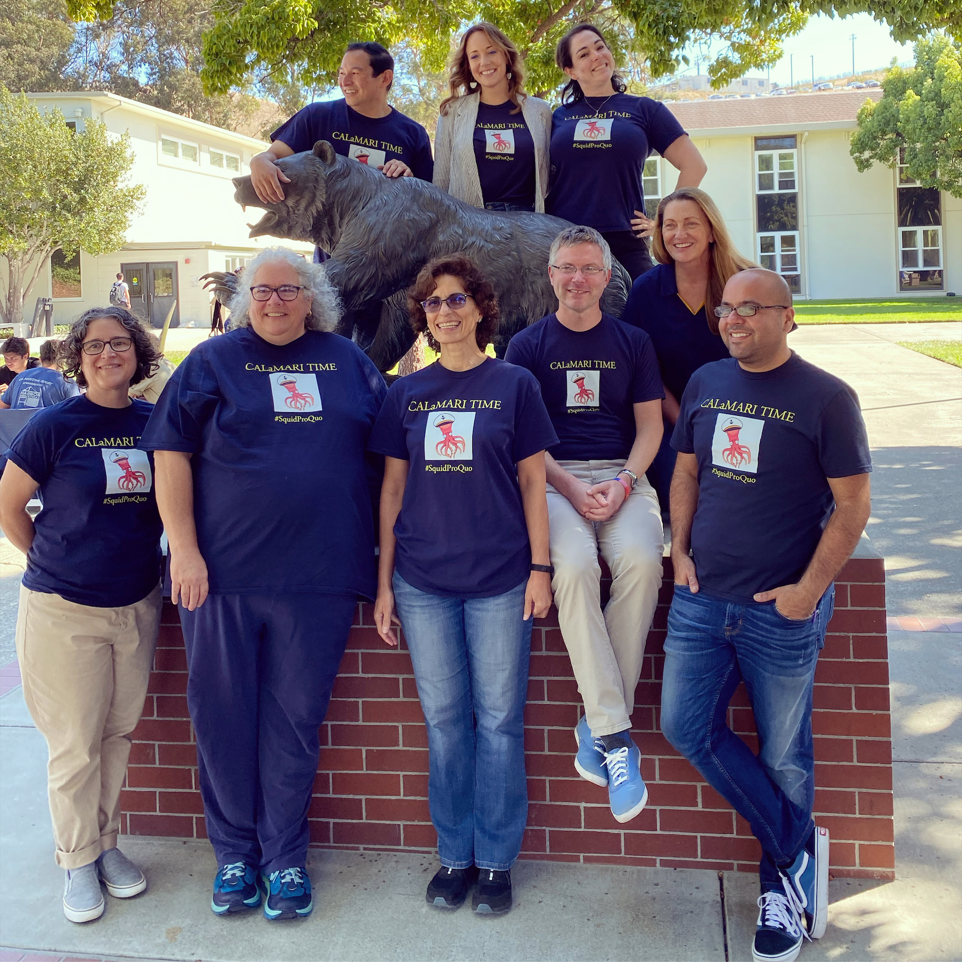 Culture and Communication Faculty posing at Keema the Bear in the quad