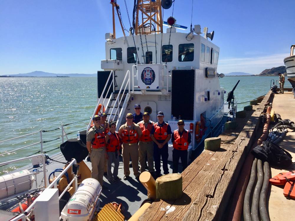 Group of cadets in lifejackets with water in background