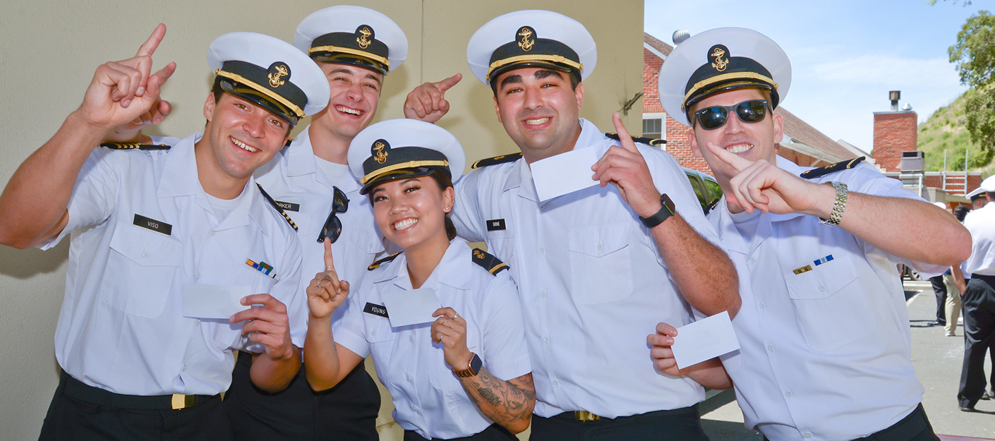 Five smiling students signing number one