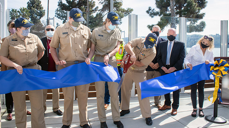 People cutting ribbon at Marketplace on campus