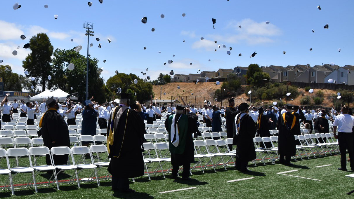 Graduates toss their hats at the end of commencement