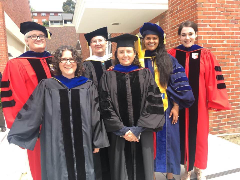 Culture and Communication Faculty in Academic regalia posing at Commencement