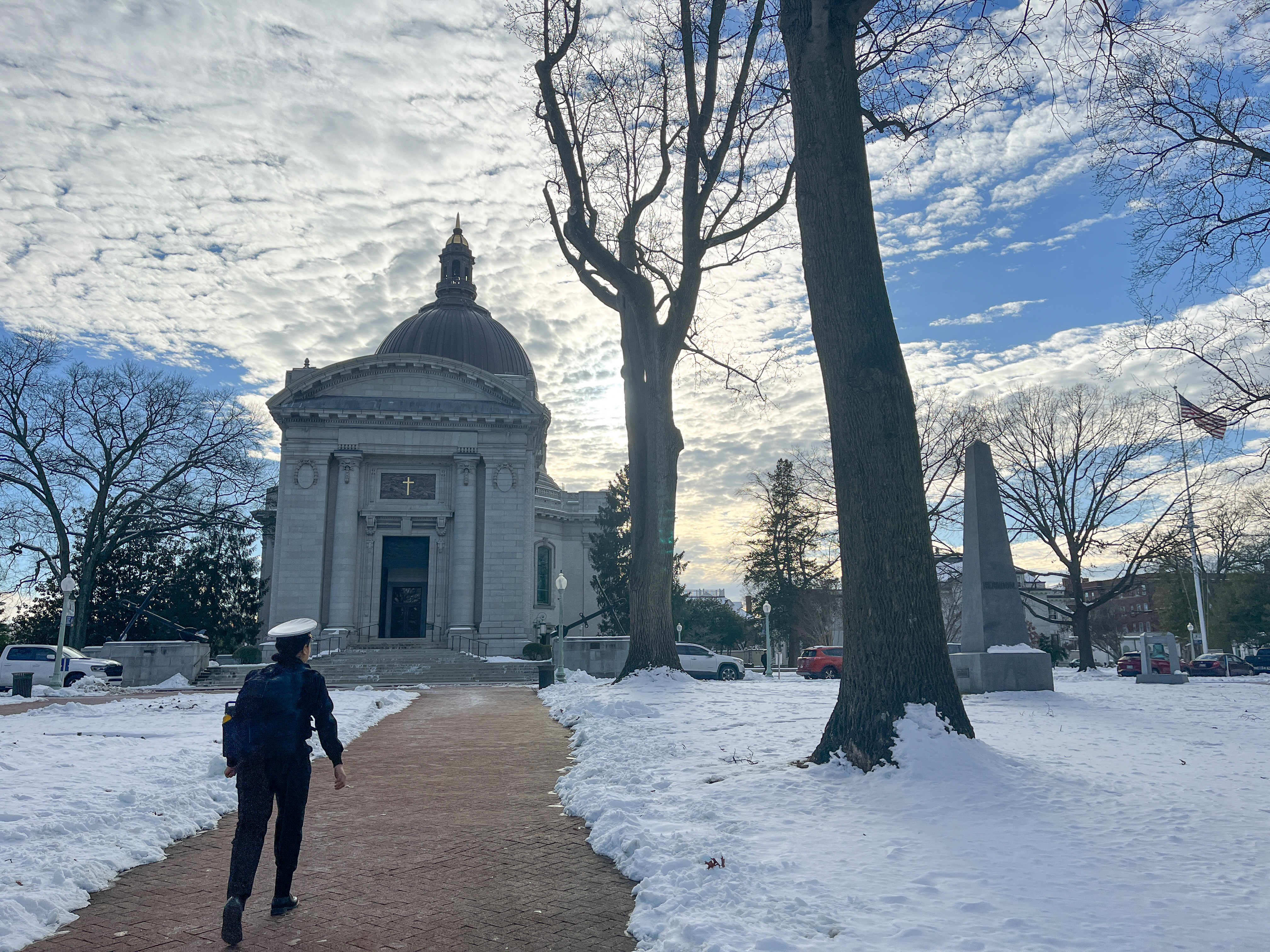 A cadet walking along a snow-lined pathway