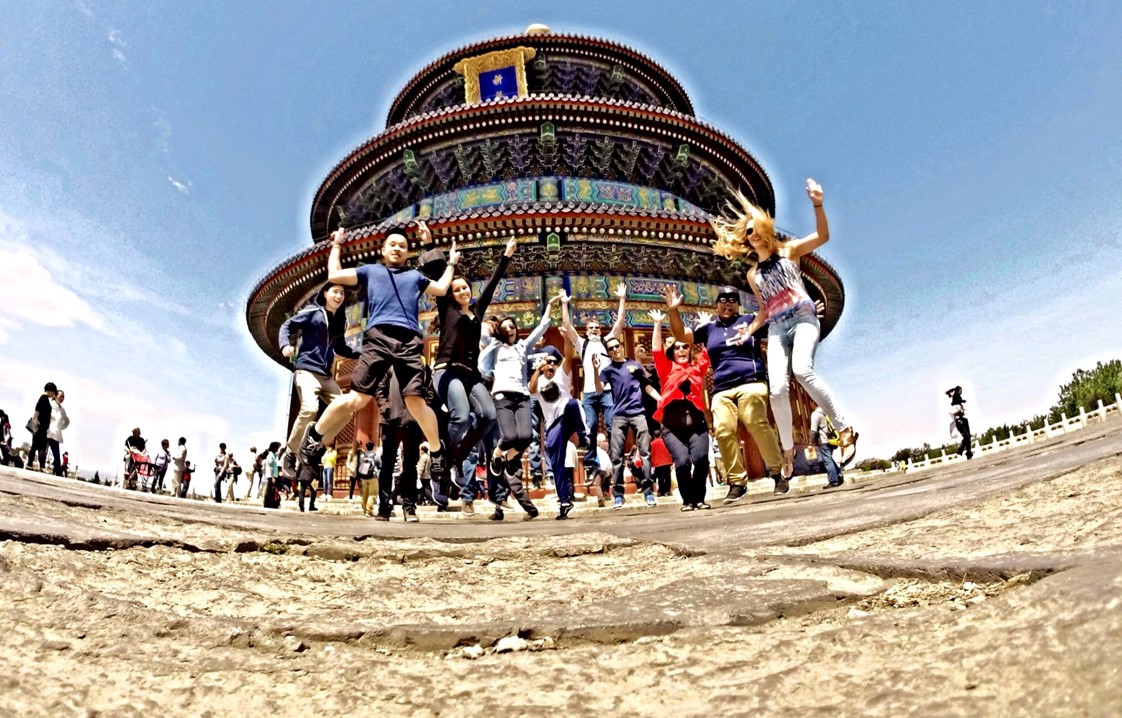 Cal Maritime China IE Picture showing students jumping in front of a padoga.