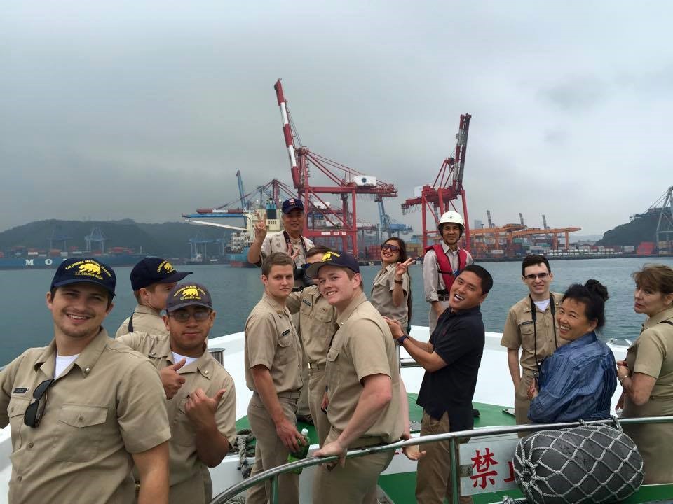 Cal Maritime International Experience Japan showing students posing in front of harbor cranes.