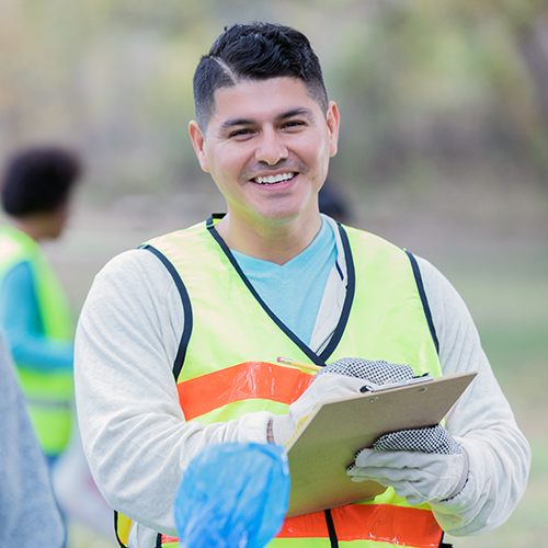 Smiling man holding clipboard