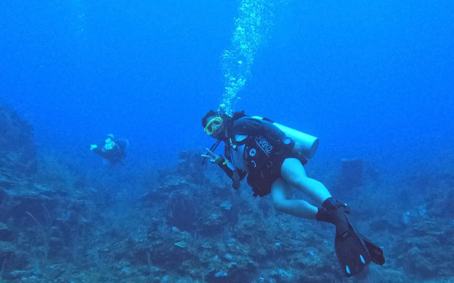 A student scuba dives in Roatan, Honduras