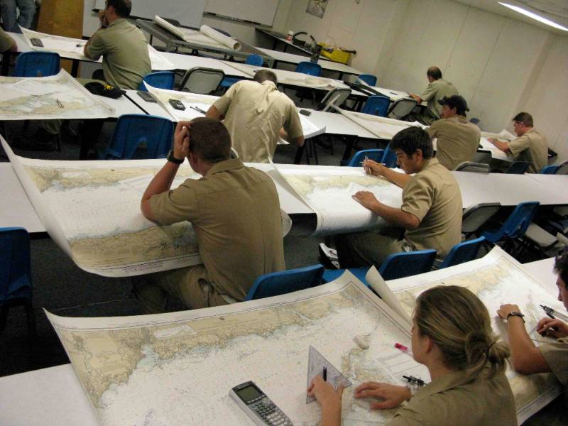 Photo of deck cadets doing chart exercise in Navigation I class.