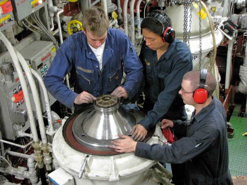 Engineering students in the engine room of the Golden Bear