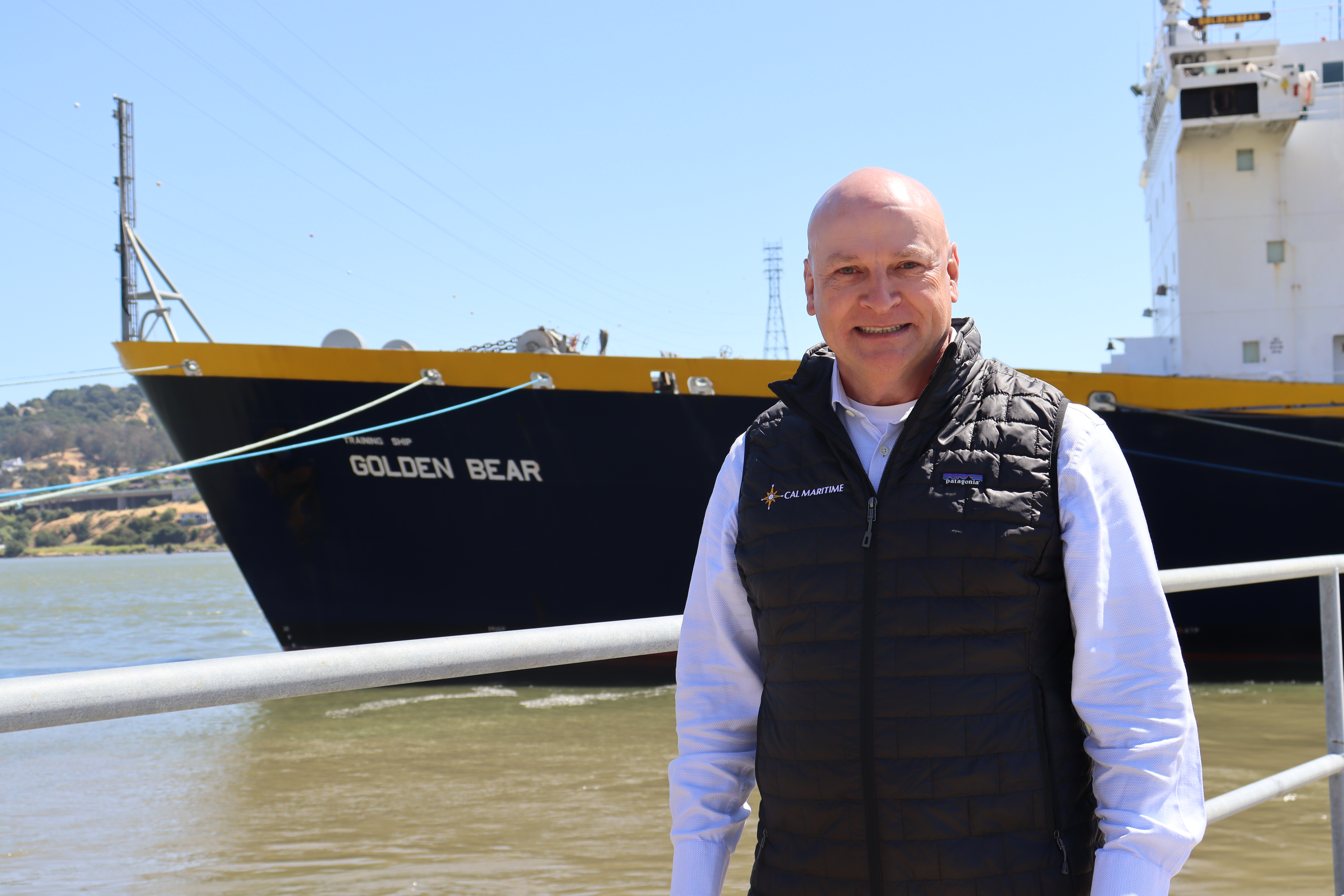 Interim President Michael J. Dumont in front of the Training Ship Golden Bear