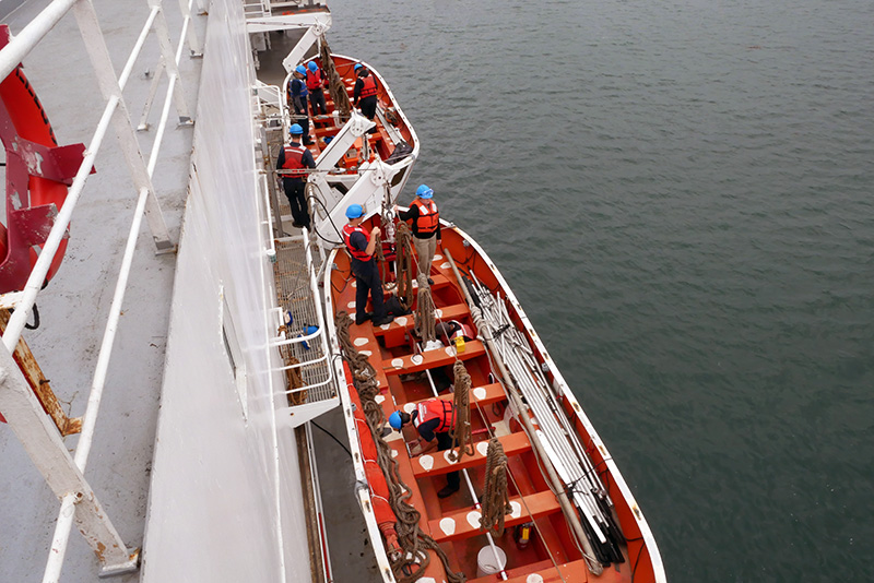 Cadets in lifeboats clearing water