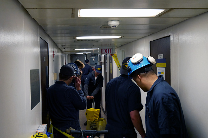 Deck cadets waxing floor