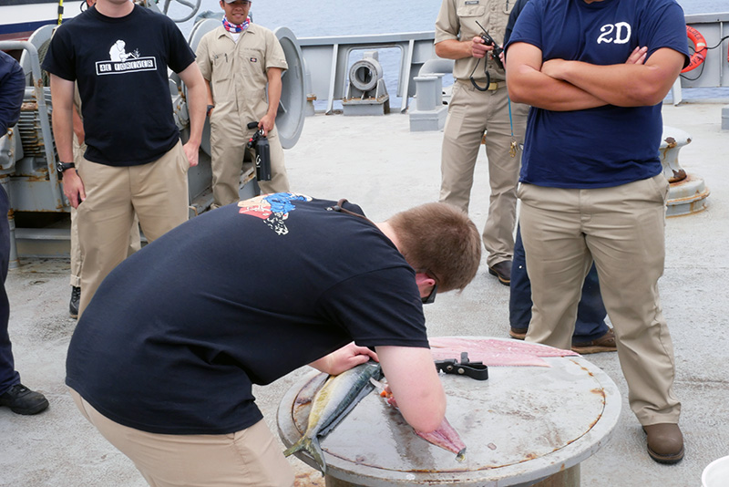 Cadet Sturgeon learning how to fillet a fish