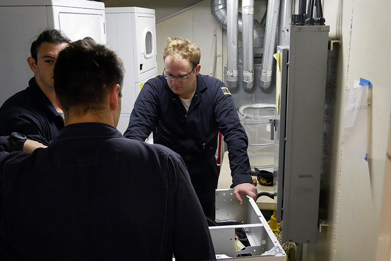 Cadets taking washer to lower berthing