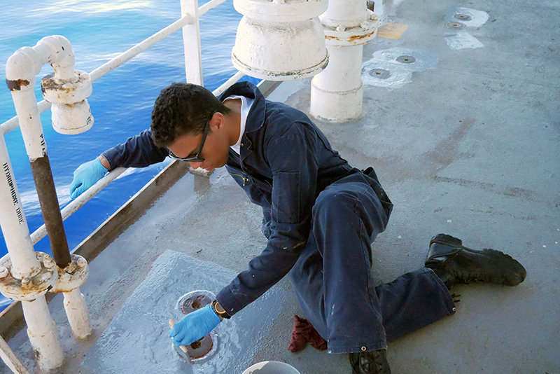 Cadet Anderson painting the deck