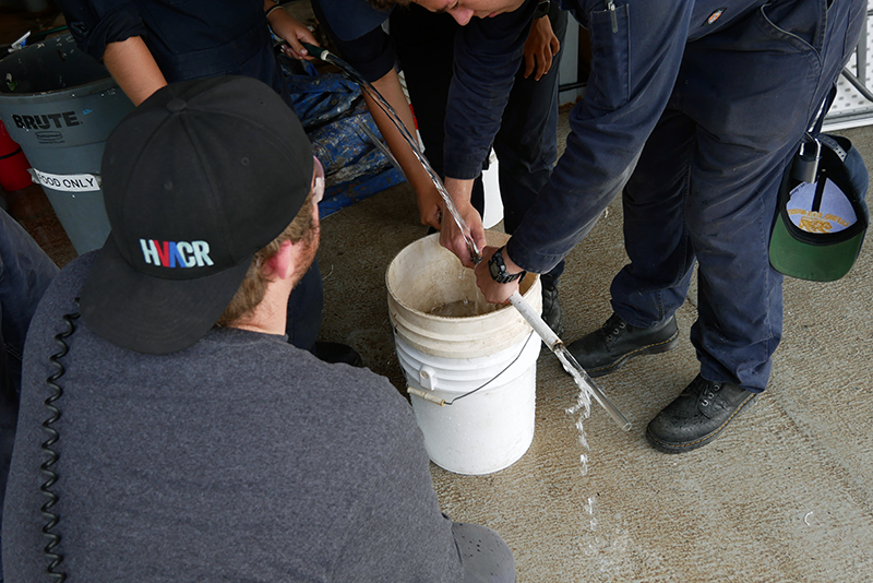Cadets pouring water into bucket