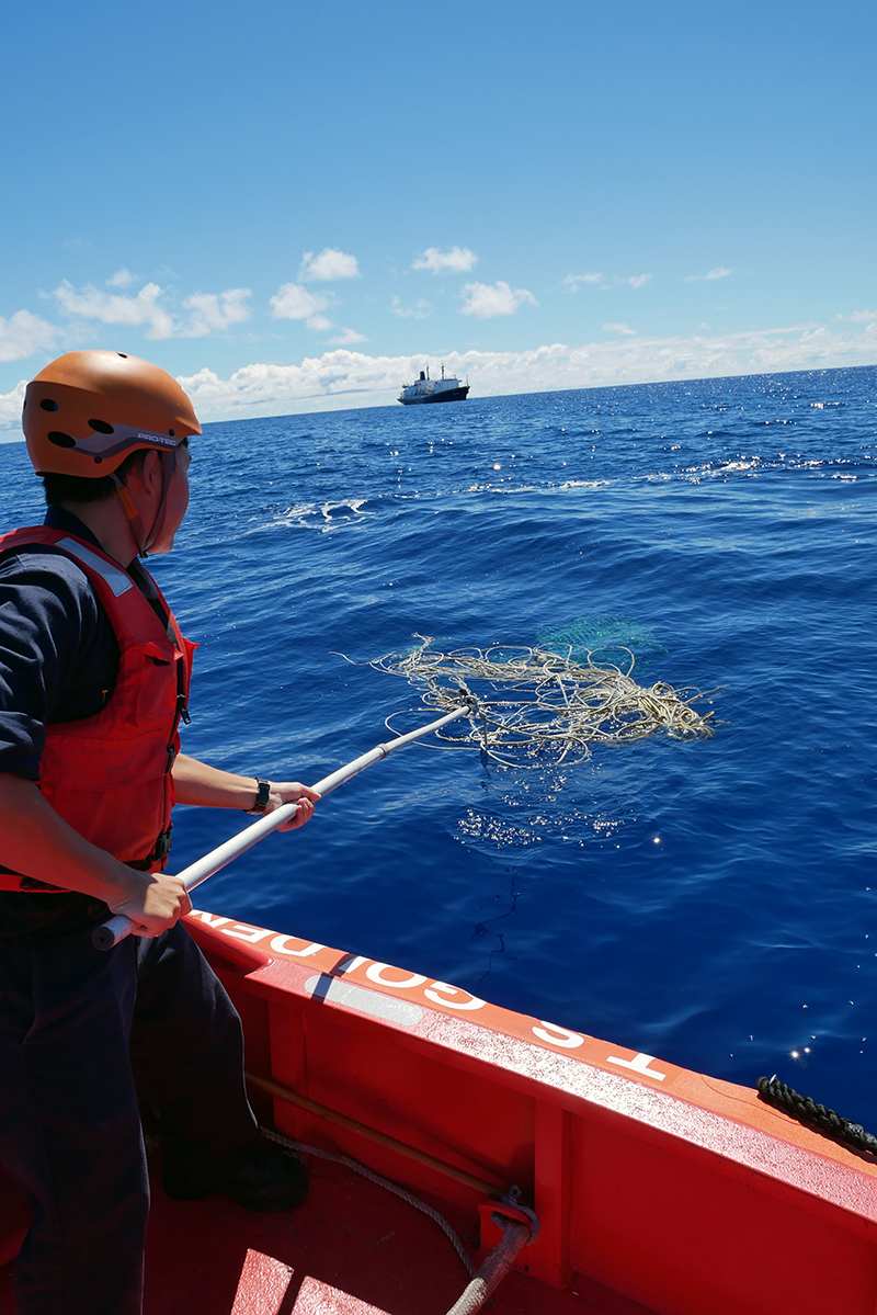 Cadet pulling in rope from rescue boat