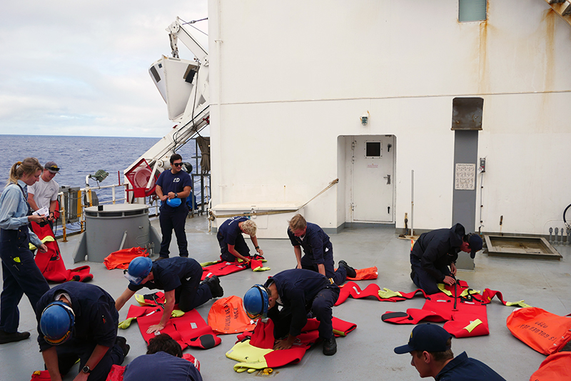 Cadets checking immersion suits on deck