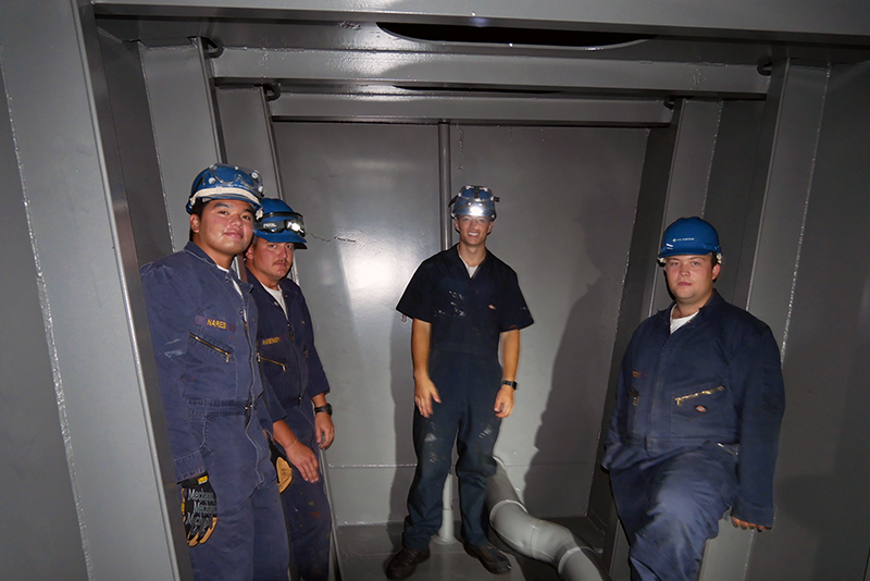 Four cadets on blue deck