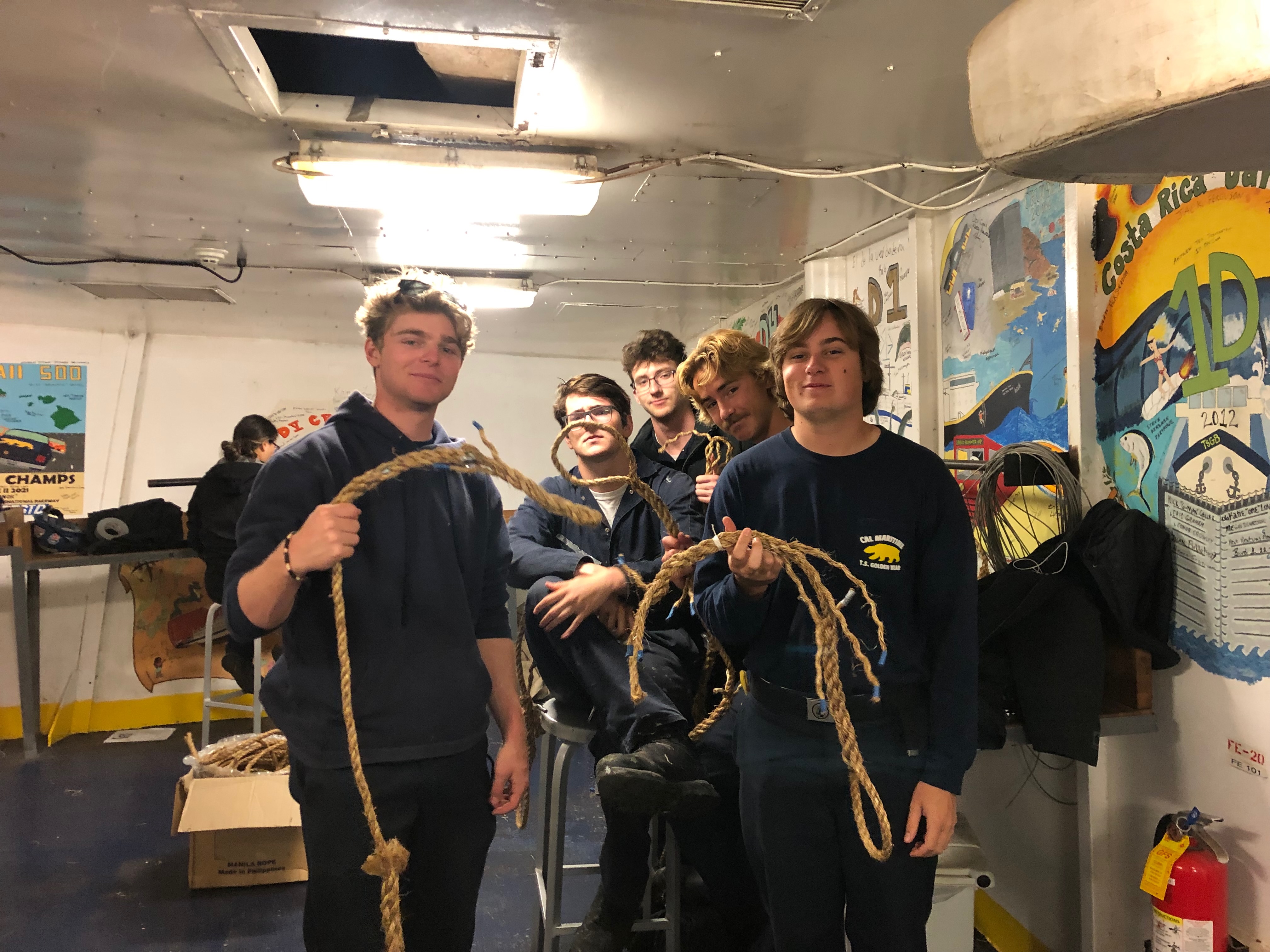 Cadets help one another with splicing line