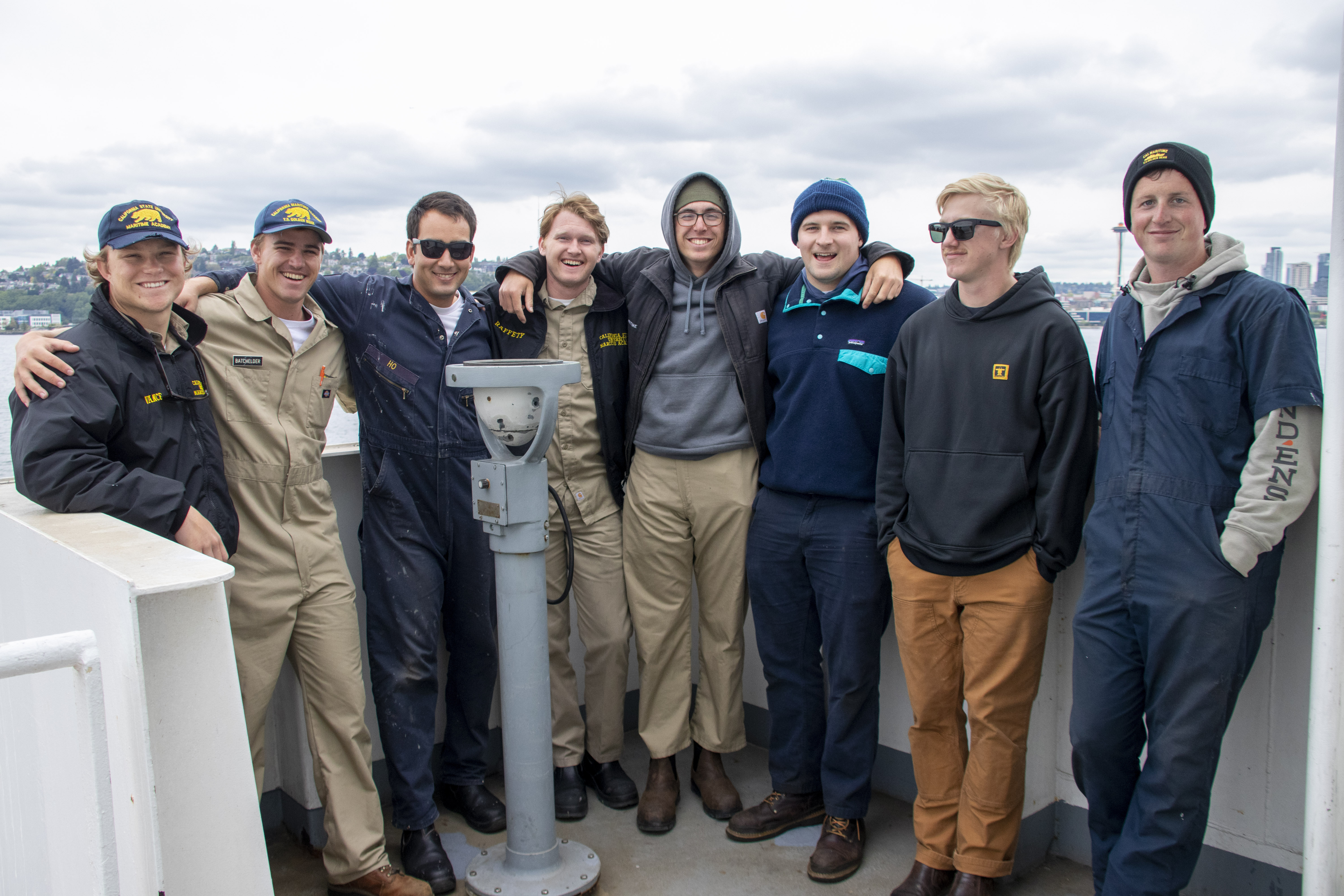 Cadets smile for the camera on the bridge wingwith the Seattle skyline in the background. Photo credit- Sophie Scopazzi