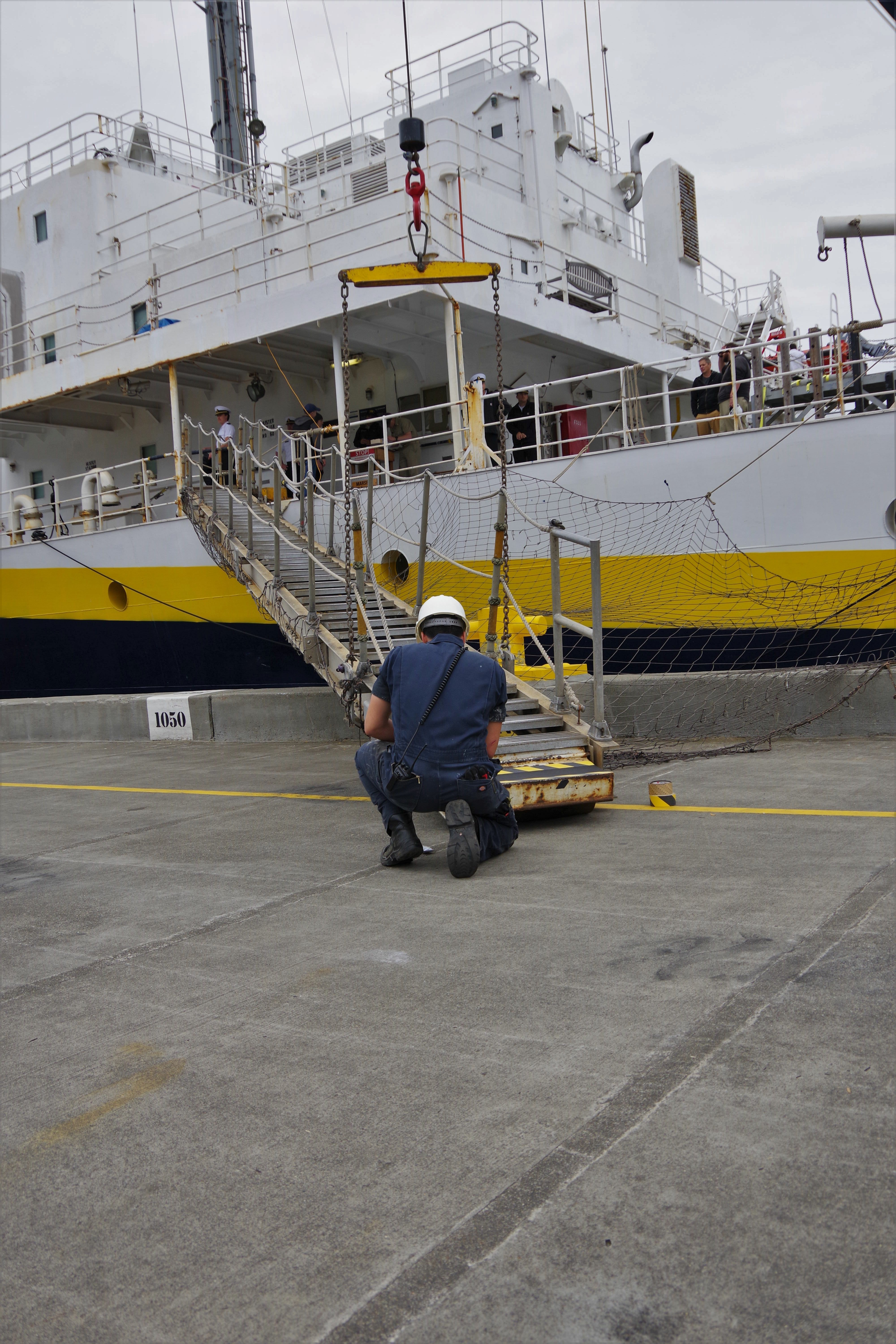 Ordinary seaman Luciano Salazano replaces nonskid on gangway- Photo credit- Emily Robison