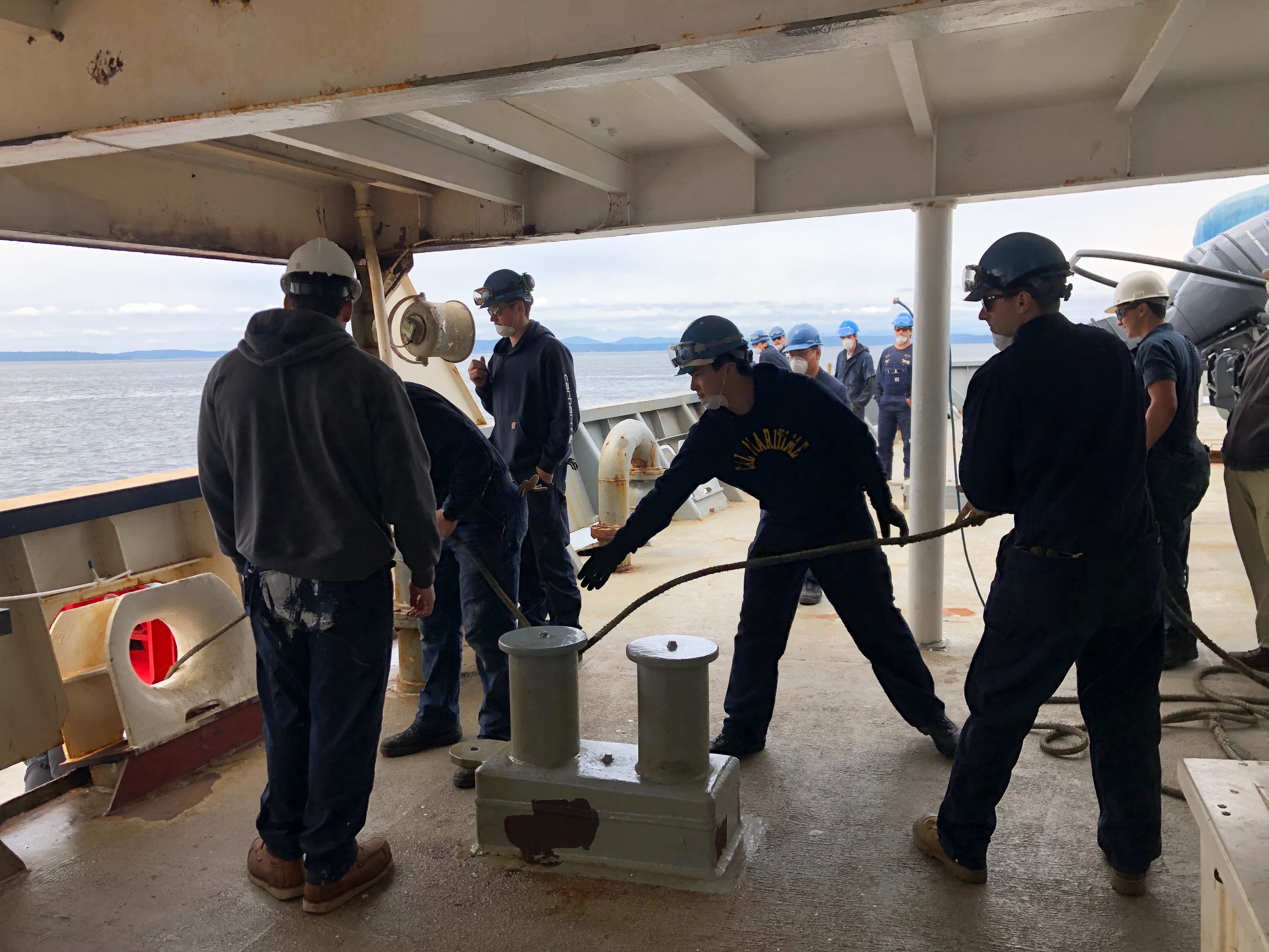 Cadets makeing tug line fast on stern with supervision of third mate Gio Boss