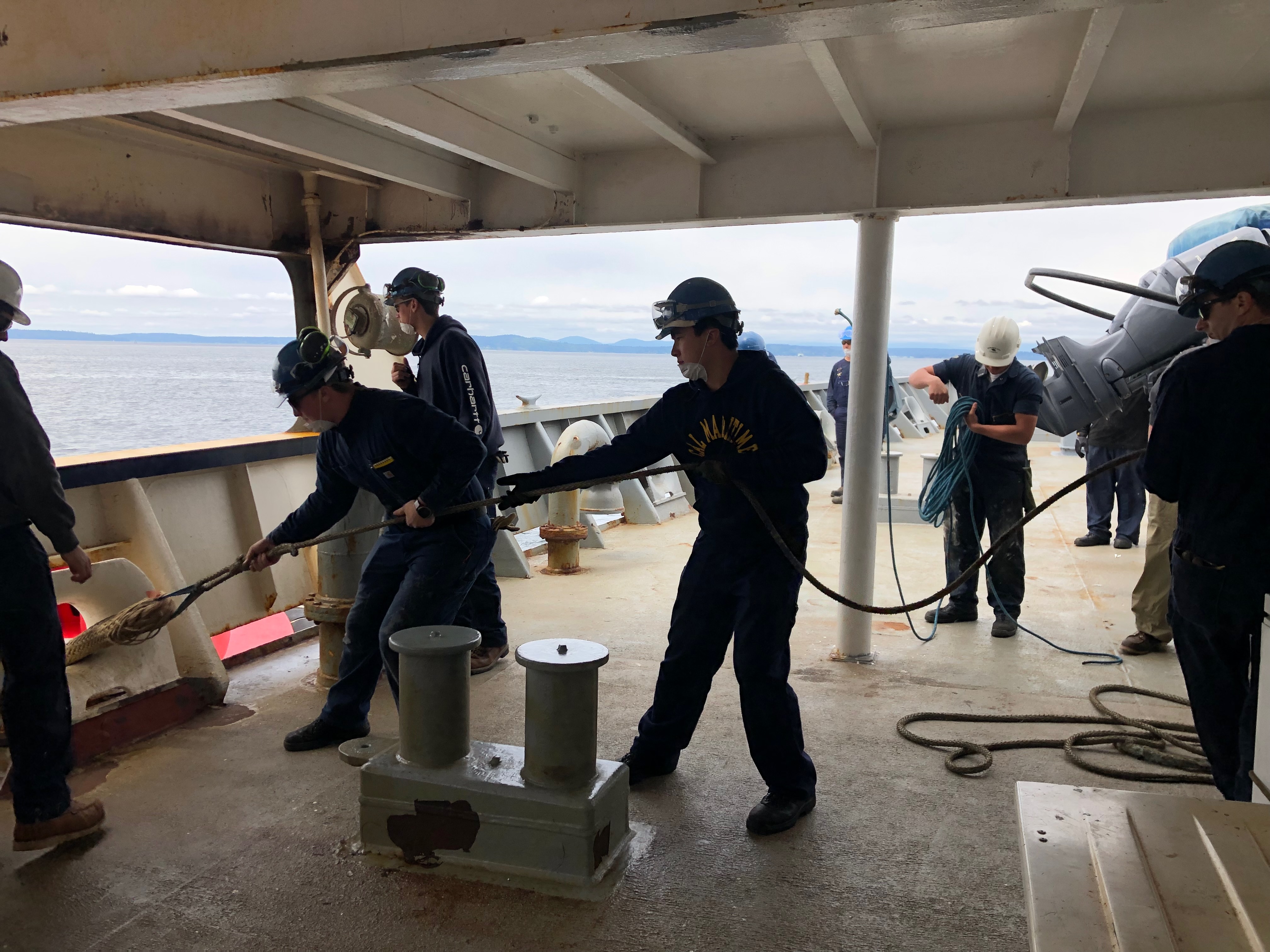 Cadets makeing tug line fast on stern with supervision of third mate Gio Boss