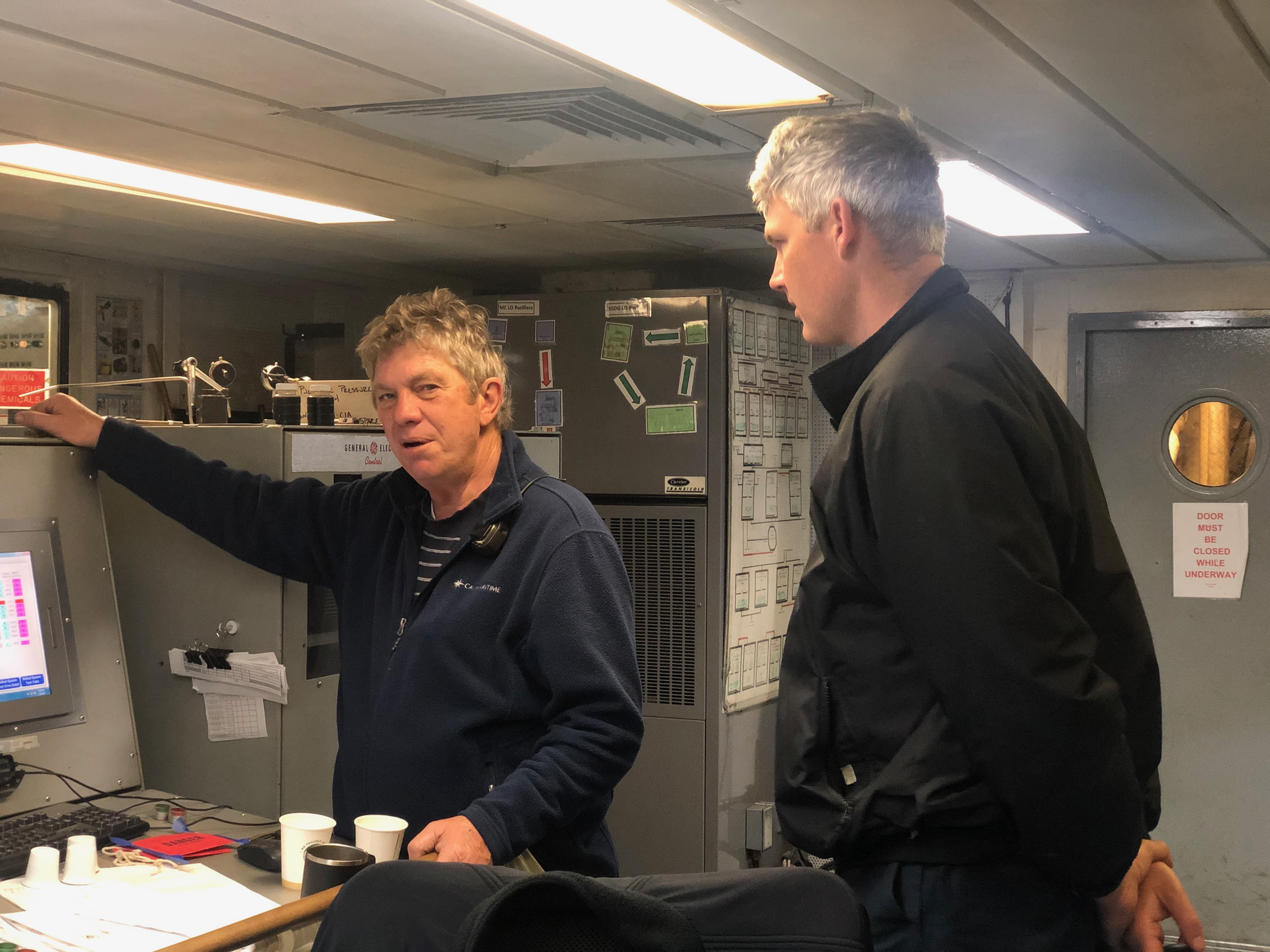 Chief mate Shonk and 1C cadet Bill Puttmann monitor ballast tank display as they they transfer ballast from one tank to another 