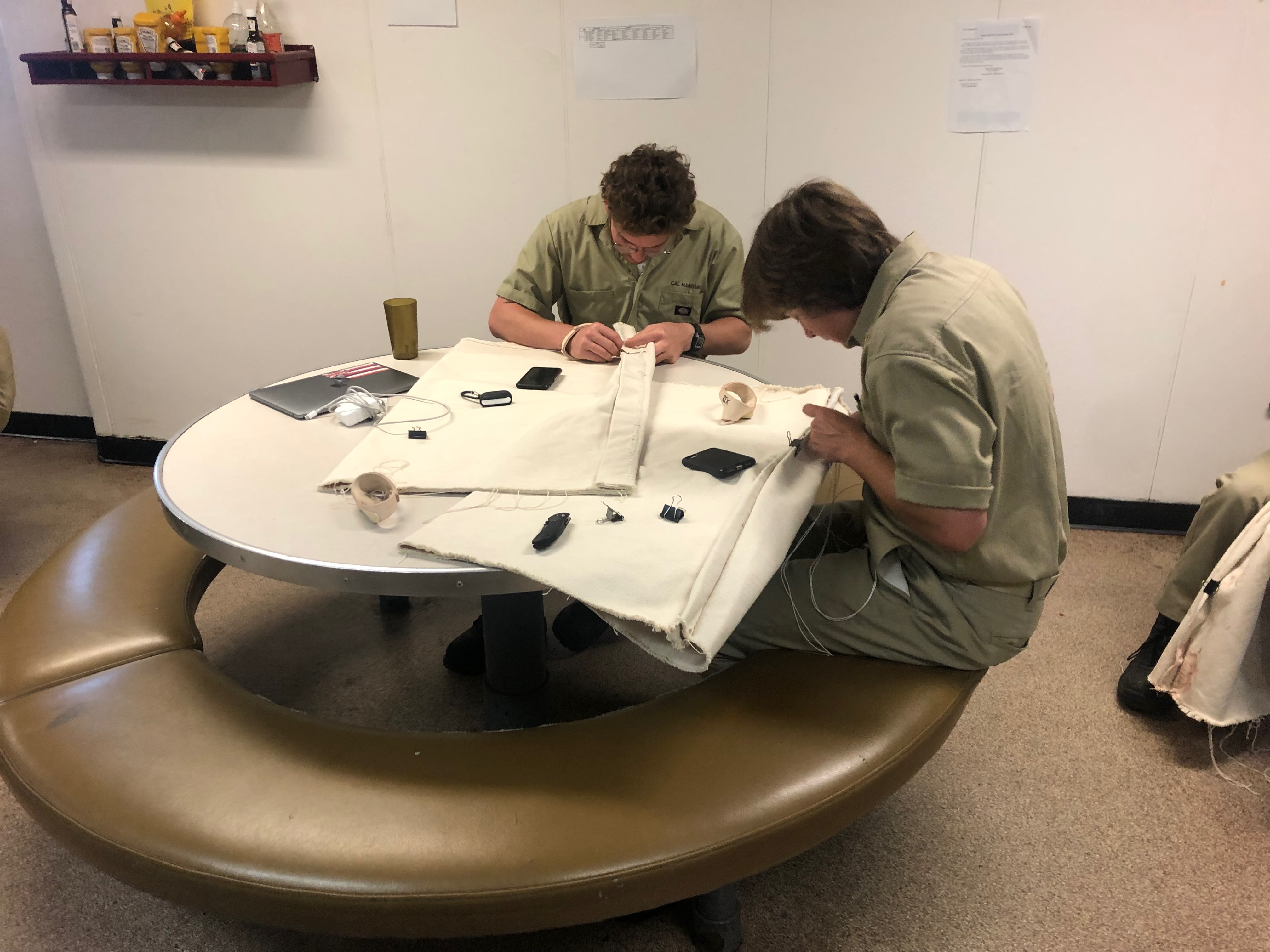 Cadets work on their canvas bags much like sailors from the days of tall ships all the way to World War II, and into the 21st century