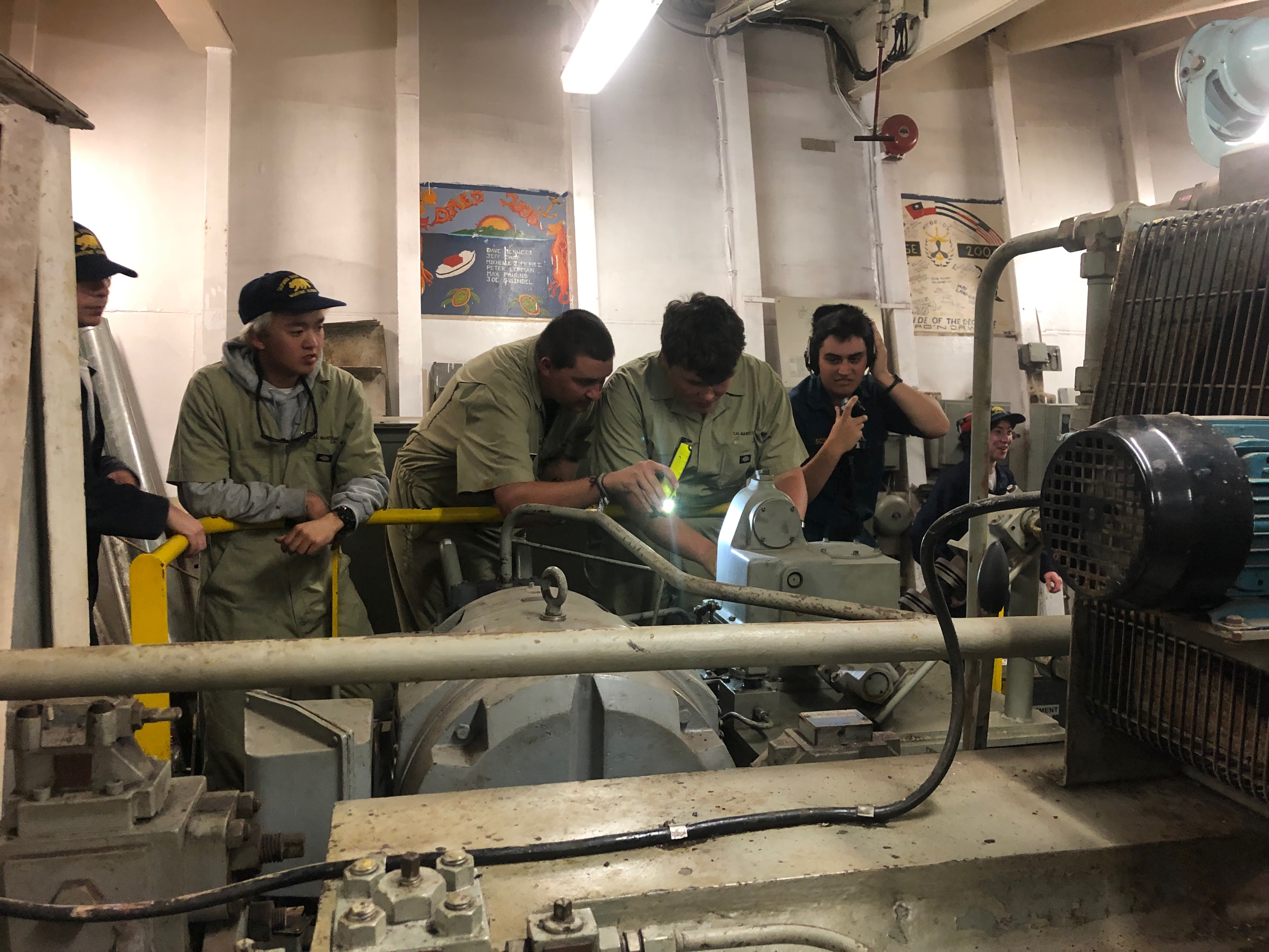 4D CO Jake Schollenberg helps 3C engineer Tobin Vaske learn how to control the rudder while 1C cadet Sophie Scopazzi gives commands 