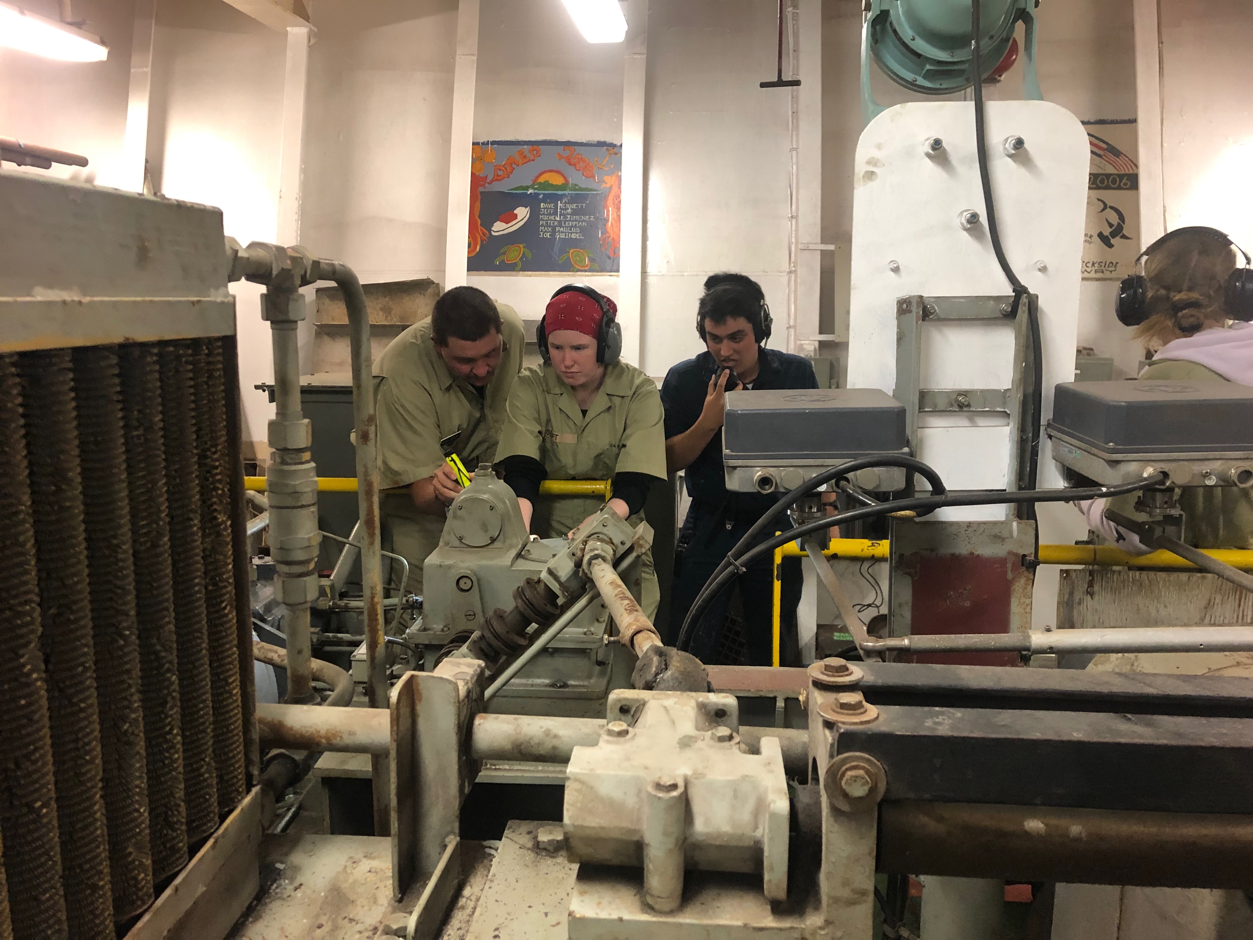 4D CO Jake Schollenberg helps 3C engineer Kierney Senft learn how to control the rudder 