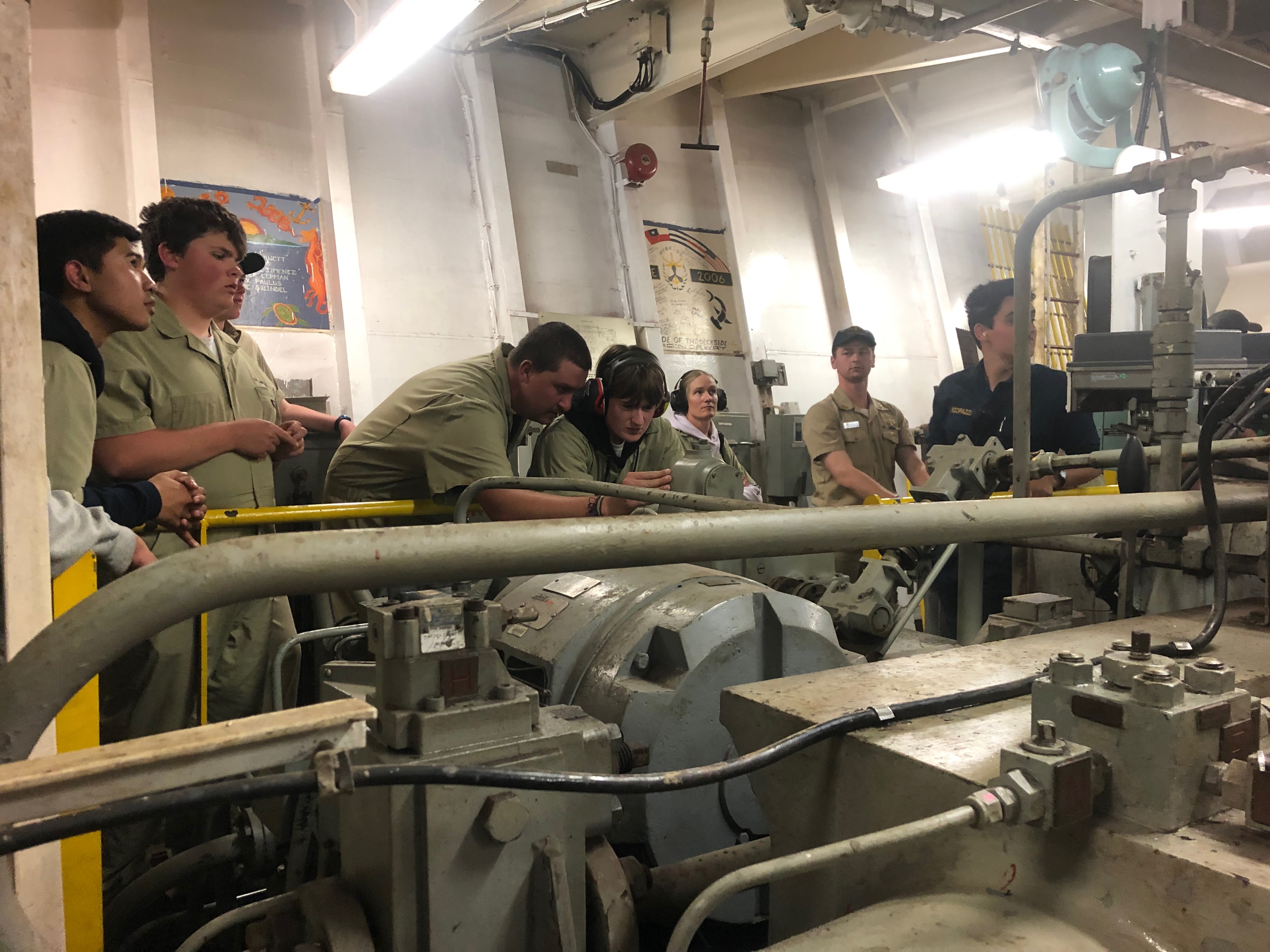 4D CO Jake Schollenberg helps 3C engineer Nat pierotti learn how to control the rudder 