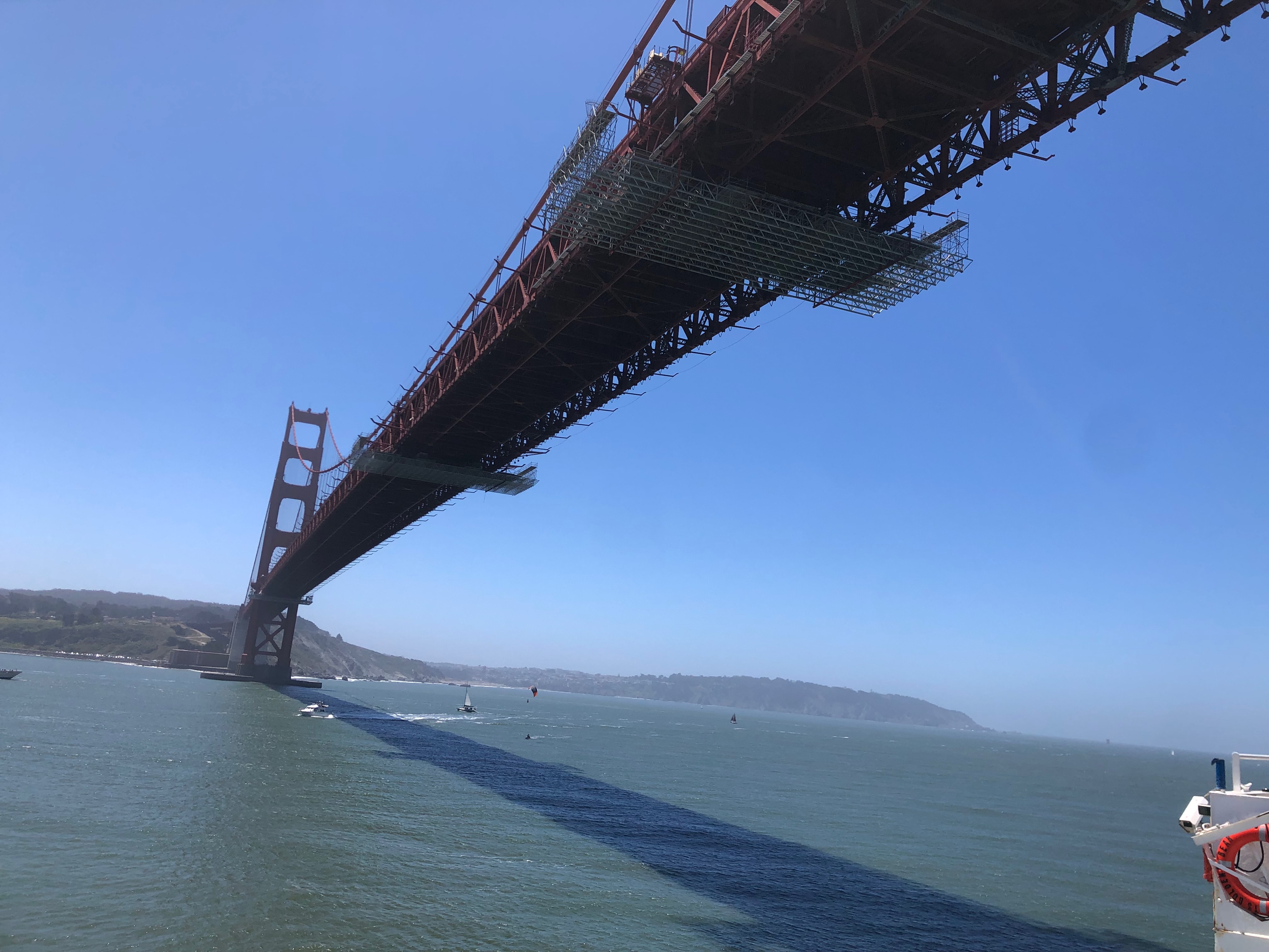 Ship heads under the San Francisco Golden Gate Bridge